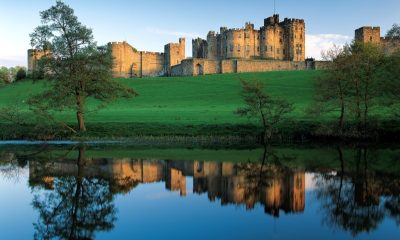 Alnwick Castle reflected in a lake